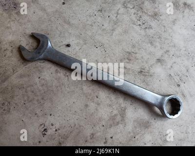 Hexagonal wrench on the dirty floor. This tool is commonly used in workshops Stock Photo