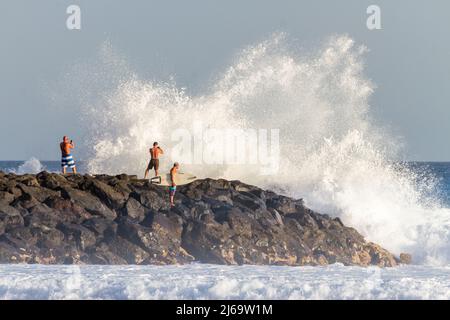 Sunset on the beach, big waves breaking against breakwater. Play Stock Photo