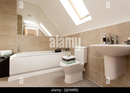 Modern tiled bathroom in neutral colours colors. Stock Photo