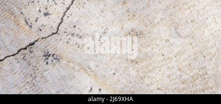 Cracked antique marble texture. Weather-cracked stone wall. Marble stone texture Stock Photo