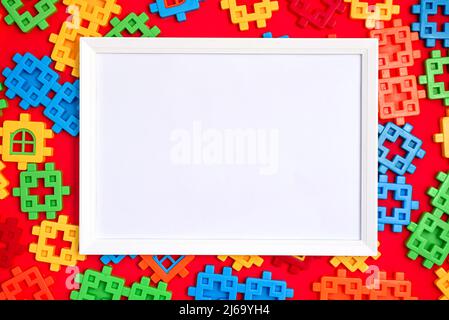 White frame mockup on Bright background texture from multi-colored plastic children's designer Stock Photo
