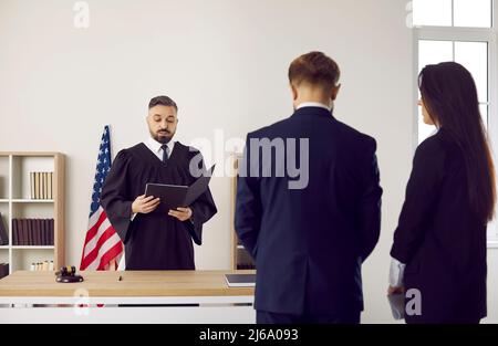 American judge in court of law gives his judgment and enforces punishment on young man Stock Photo