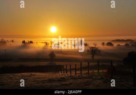 Sunrise over a farm house in the Vale of York at Crayke North yorkshire Stock Photo