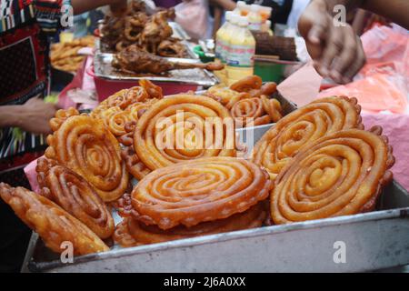 Dhaka, Bangladesh. 29th Apr, 2022. Chawk Bazar iftar market in Dhaka is well known for traditional spicy foods. Thousands of people gathered on a road in front of Chawk Bazar Shahi Mosque where sellers displayed plenty of traditional food items. (Photo by Tahsin Ahmed/Pacific Press) Credit: Pacific Press Media Production Corp./Alamy Live News Stock Photo