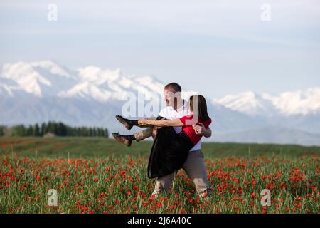 Poppy fields near Leninskoe village near the city of Bishkek in Kyrgyzstan. Stock Photo