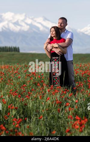 Poppy fields near Leninskoe village near the city of Bishkek in Kyrgyzstan. Stock Photo