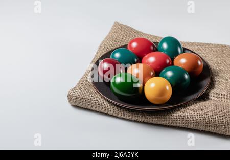 Ceramic plate with multicolor easter eggs on white background, stock photo Stock Photo