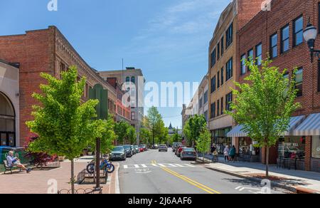 ASHEVILLE, NC, USA-28 APRIL 2022: Iconic wide angle view down Haywood street in downtown. People on sidewalk, detailed historic building facades, chur Stock Photo