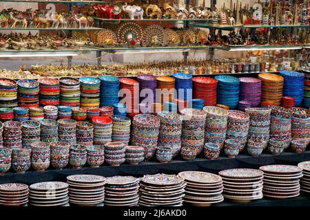 arabian style colorful ceramic plates and cutlery for sell in a street market stall Stock Photo