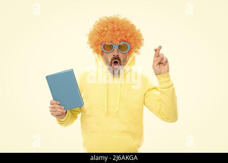Superstitious idea. Superstitious man hold book. Keeping fingers crossed for luck Stock Photo