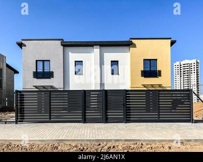 Exterior view of a modern townhouse. The concept of outdoor buildings of multi-apartment residential townhouses Stock Photo