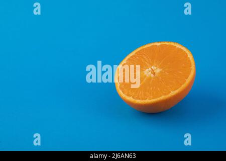 Halved navel orange on solid blue background Stock Photo