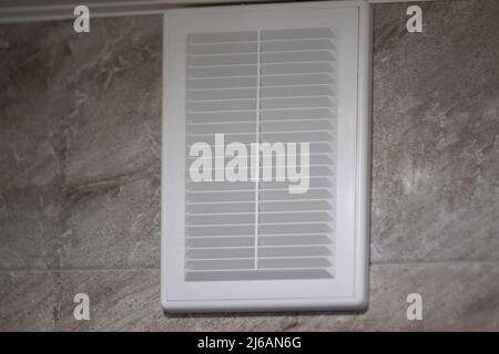 Ventilation grille in white on gray marble tiles Stock Photo