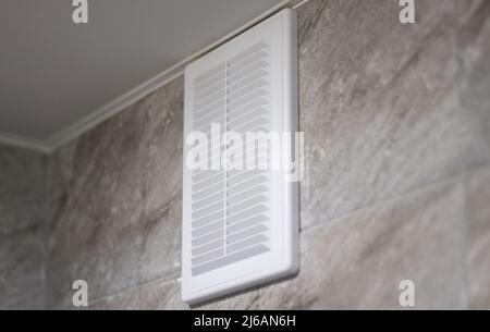 Ventilation grille in white on gray marble tiles Stock Photo