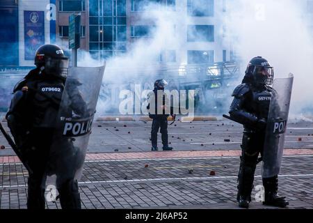 April 28, 2022, BogotÃ, Cundinamarca, Colombia: Riot police on guard with police shields during the demonstration. Students clashed heavily with riot police at BogotÃ university as they marched to commemorate the day when the 2021 National Strike began in Colombia. (Credit Image: © Antonio Cascio/SOPA Images via ZUMA Press Wire) Stock Photo