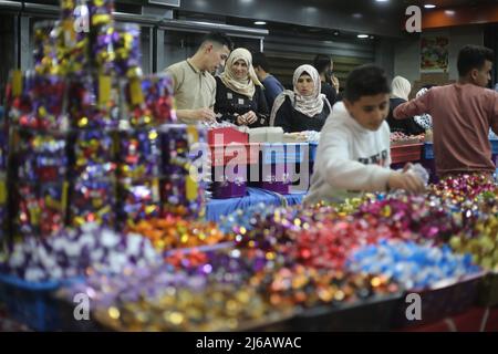 (220430) -- GAZA, April 30, 2022 (Xinhua) -- A vendor sells candies at a market ahead of Eid al-Fitr in the southern Gaza Strip city of Rafah, April 29, 2022. (Photo by Khaled Omar/Xinhua) Stock Photo