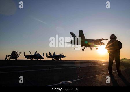 April 19, 2022 - USA - Aviation Boatswain's Mate (Equipment) 1st Class Aaron Wilson, from Atlanta, assigned to USS Gerald R. Ford's (CVN 78) air department, stands watch as the arresting gear officer as an F/A-18E Super Hornet, attached to the 'Golden Warriors' of Strike Fighter Squadron (VFA) 87, prepares to land on the flight deck, April 19, 2022. Ford is underway in the Atlantic Ocean conducting carrier qualifications and strike group integration as part of the shipâ€™s tailored basic phase prior to operational deployment. (Credit Image: © U.S. Navy/ZUMA Press Wire Service/ZUMAPRESS.com) Stock Photo