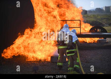 Apr 7, 2022 - Vandenberg Space Force Base, California, USA - A team of firefighters put out a fire around a training aircraft during the joint firefighter integrated readiness ensemble training exercise on Vandenberg Space Force Base, Calif., April 7, 2022. The Vandenberg Fire Department trains on JFIRE annually to retain their certification. (Credit Image: © U.S. Space Force/ZUMA Press Wire Service/ZUMAPRESS.com) Stock Photo