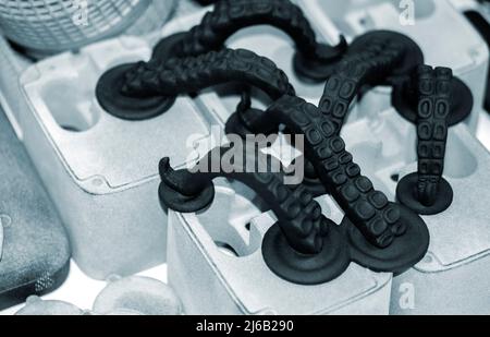 Models printed on 3D printer. Black objects printed on 3D printer made plastic Stock Photo