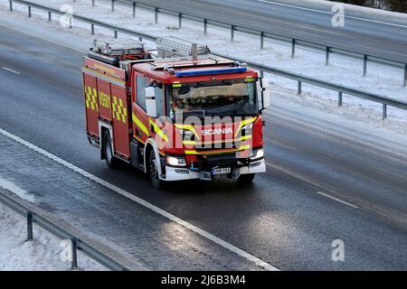 Scania P CrewCab fire truck at speed on motorway on a day of winter. Salo, Finland. December 31, 2021. Stock Photo