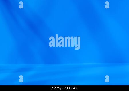 Empty blue studio space with deep artistic shadow. Minimalistic space concept Stock Photo