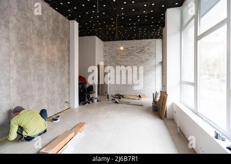 renovated room with shopping window - empty store shop with wooden floor and white walls Stock Photo