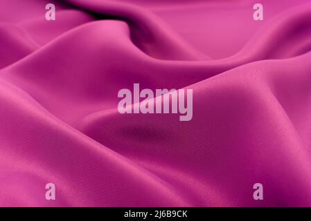 Fabric of purple cloth. Fabric texture for background and design works of art, beautiful wrinkled pattern of silk or linen. A crumpled piece of cloth Stock Photo