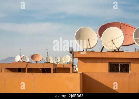 Many dish antennas on rooftops in a town in Morocco Stock Photo