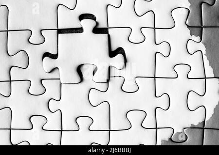 jig saw puzzle with one piece floating above the surface Stock Photo