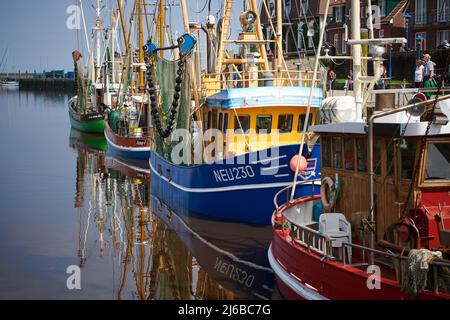 Neuharlingersiel, Germany - August 15, 2021: Colorful fishing vessels in the port of Neuharlingersiel Stock Photo