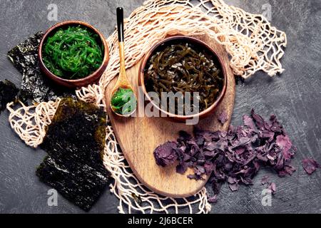 Seaweed assortment on fark background. Healthy snacks. Top view, flat lay Stock Photo