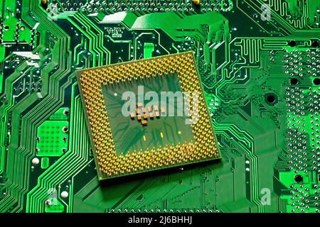 Macro Close up of microchips and pins on Main CPU PC processor circuit board. Stock Photo