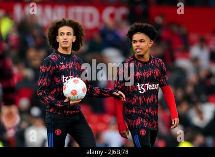 Manchester United's Hannibal Mejbri (left) and Shola Shoretire warm up ahead of the Premier League match at Old Trafford, Manchester. Picture date: Thursday April 28, 2022. Stock Photo