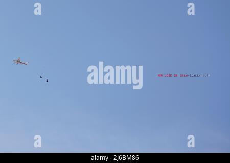 A plane flying over the stadium with a message saying WIN LOSE OR DRAW - SCALLY OUT during the Sky Bet League One match at the MEMS Priestfield Stadium, Gillingham. Picture date: Saturday April 30, 2022. Stock Photo