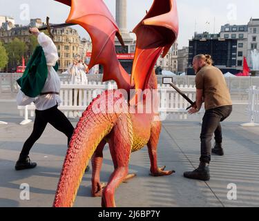 London, Greater London, England, April 23 2022: Staff at the St Georges day celebration in Trafalgar Square pretending to fight the dragon. Stock Photo