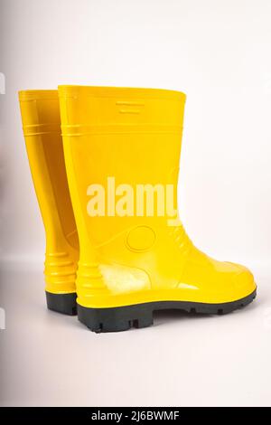 Robust and waterproof yellow rubber boots isolated on white background Stock Photo