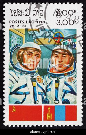 LAOS - CIRCA 1983: a stamp printed in Laos shows Cosmonauts and Flags of USSR and Mongolia, Intercosmos Space Cooperation Program, circa 1983 Stock Photo