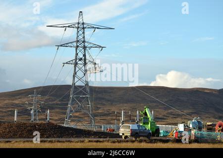 Overhead power line construction work at Loch Buidhe near Lairg in the Scottish Highlands to allow for more renewable energy generation. Stock Photo