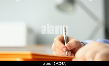 Male hand writing personal address on yellow envelope Stock Photo