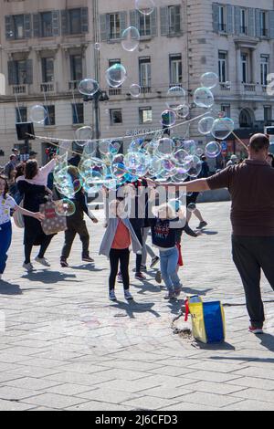 Children playing with soap bubbles Stock Photo