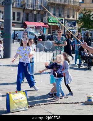 Children playing with soap bubbles Stock Photo