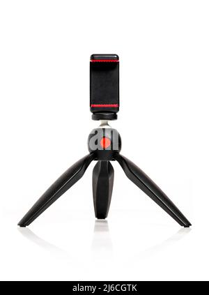 Mini travel tripod for smartphone on isolated white background Stock Photo