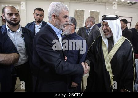 30 April 2022, Palestinian Territories, Gaza: Yahya Sinwar (L), leader of the Palestinian Hamas Islamist movement in the Gaza Strip attends a meeting with people at a hall on the sea side of Gaza City. Photo: Mohammed Talatene/dpa Stock Photo