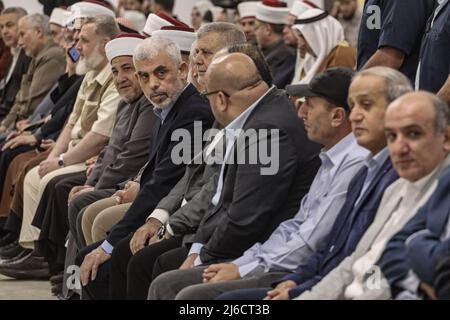 30 April 2022, Palestinian Territories, Gaza: Yahya Sinwar (C), leader of the Palestinian Hamas Islamist movement in the Gaza Strip attends a meeting with people at a hall on the sea side of Gaza City. Photo: Mohammed Talatene/dpa Stock Photo