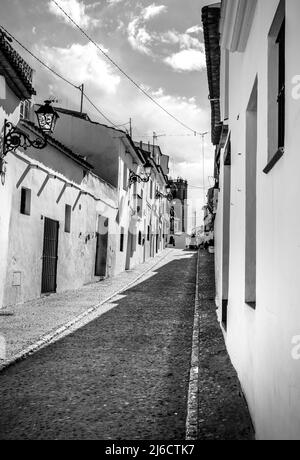 Narrow cobblestone streets and whitewashed facades of Ronda city ...