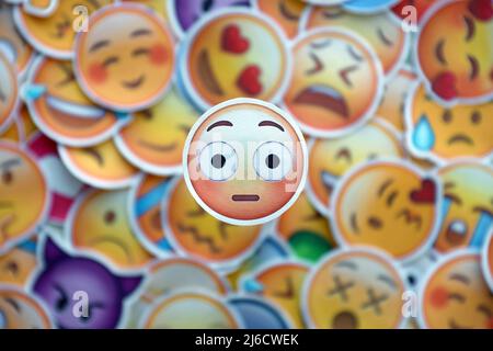 TERNOPIL, UKRAINE - APRIL 29, 2022: Large set of stickers with Emoji yellow faces. Wow pictogram in focus zone Stock Photo