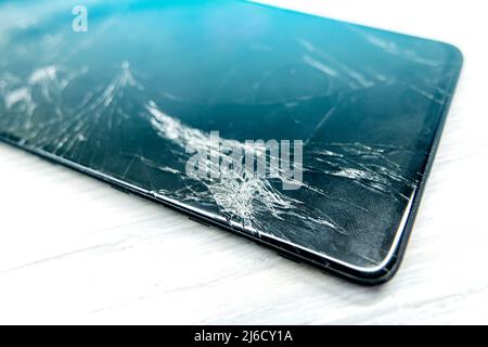 a broken mobile phone screen in the master's hand. Stock Photo