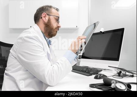 Doctor using his tablet computer at work. High quality photo Stock Photo