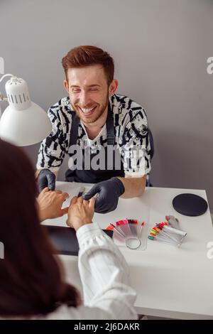 Nail master working on client nails at beauty center Stock Photo