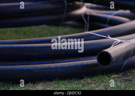 Large black plastic pipes for water supply closeup Stock Photo